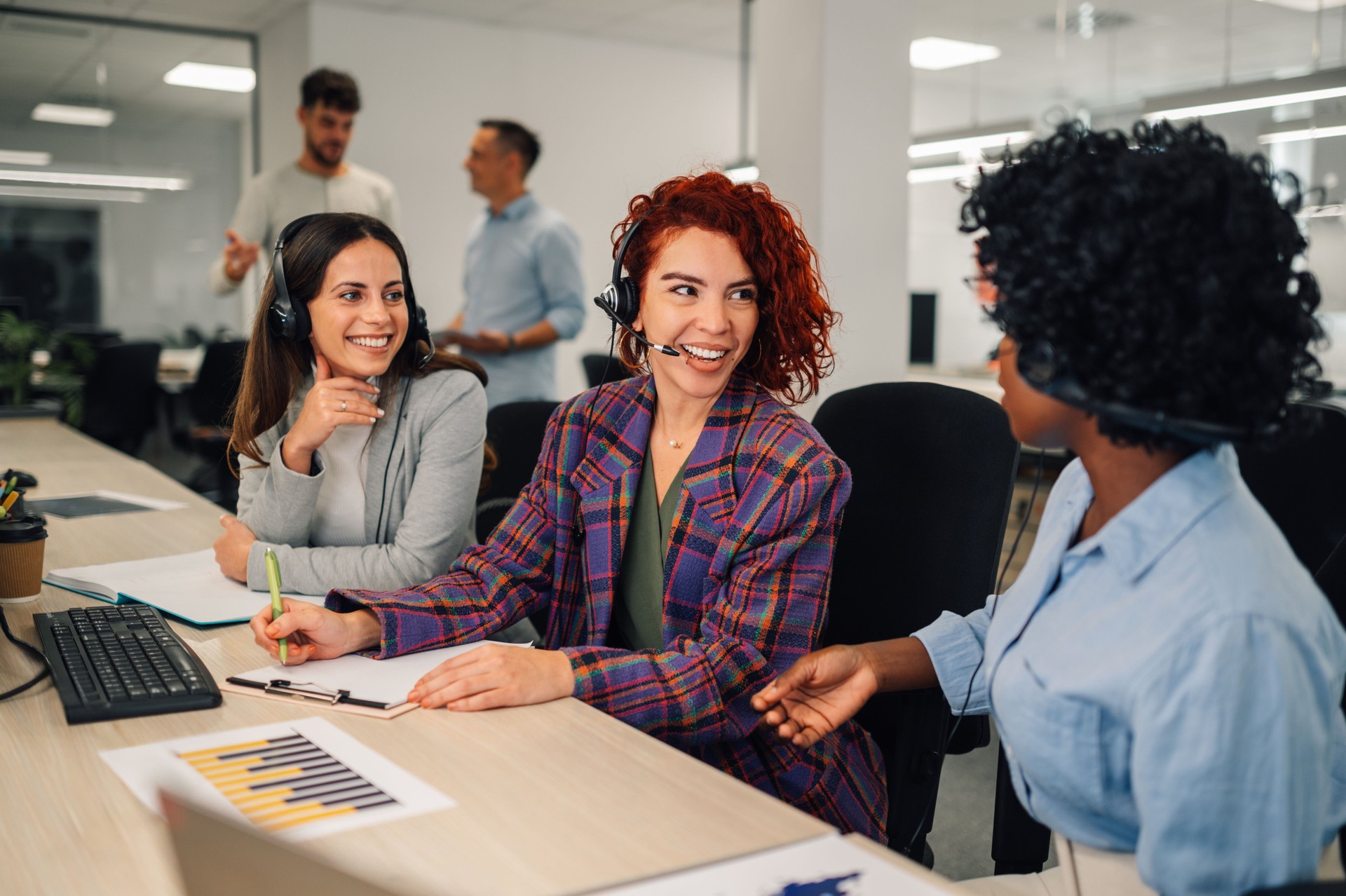 Portrait of multicultural customer support agents at call center.